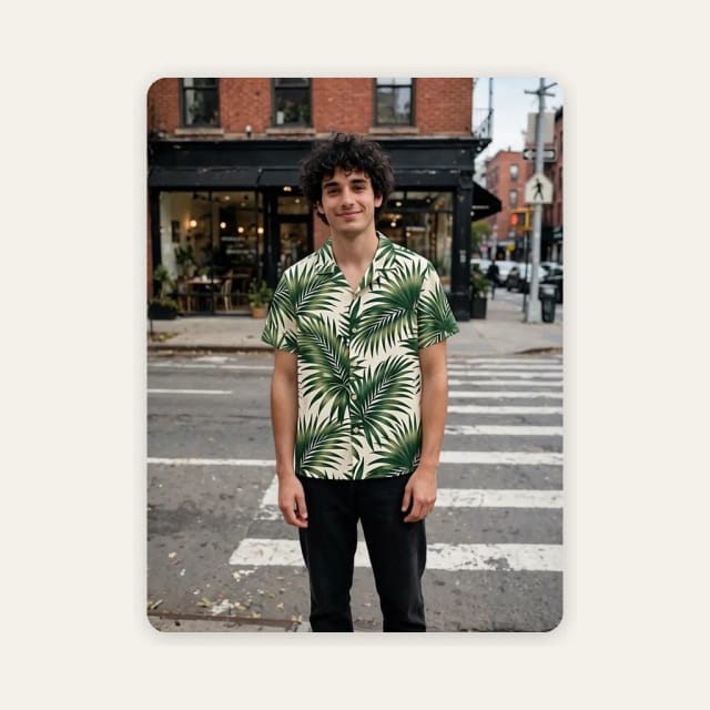The same man wearing the palm print shirt, with his jeans unchanged