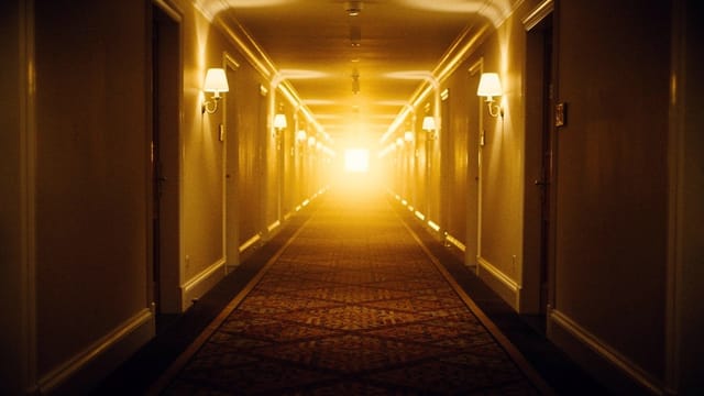 A long corridor shot receding into warm light